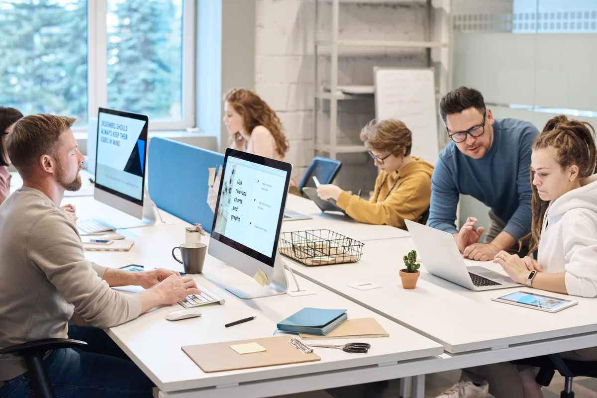 A delivery floor of engineers working at desks in an open-plan office